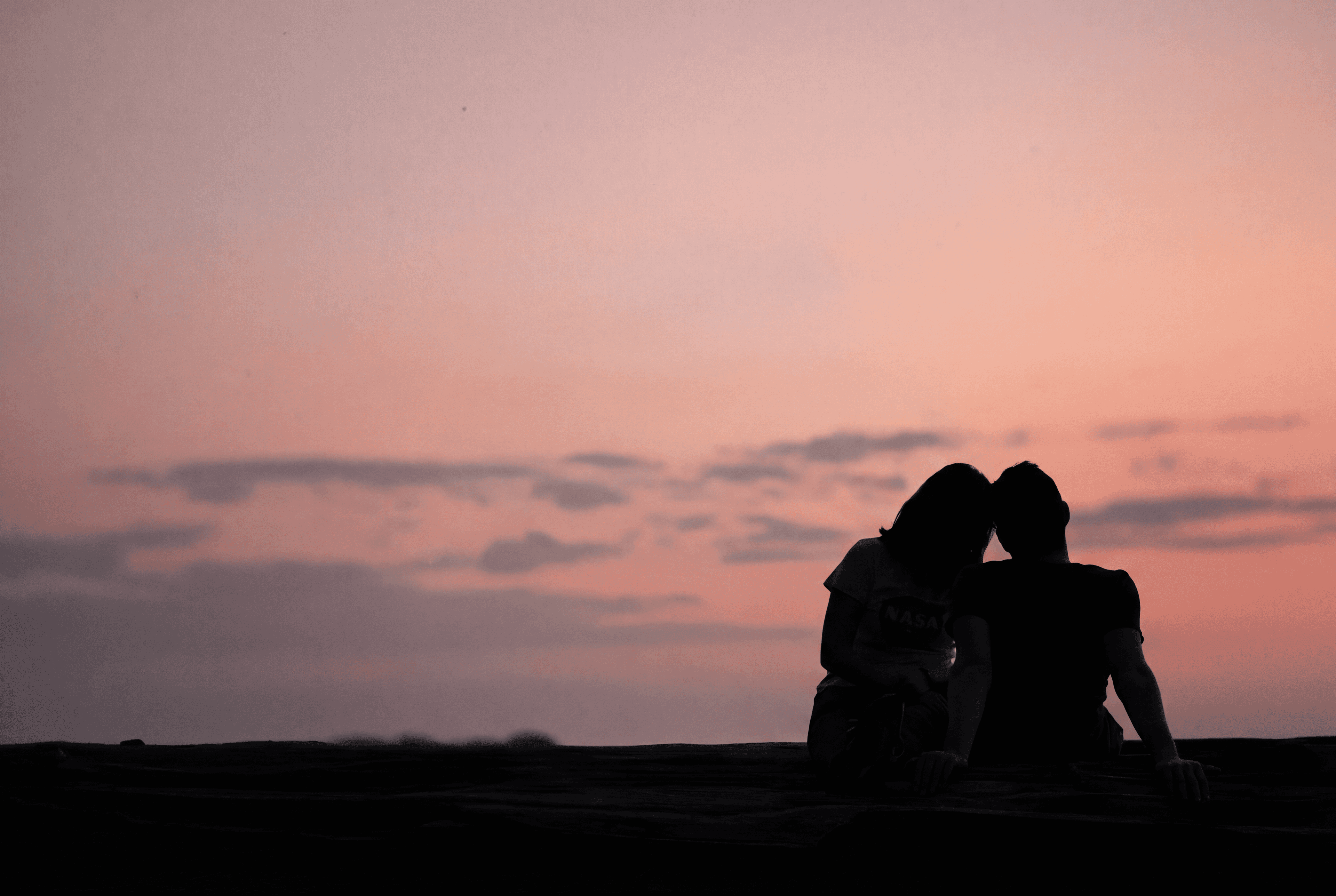 A couple enjoying a romantic sunset together